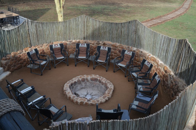 Circular boma with fire pit and chairs