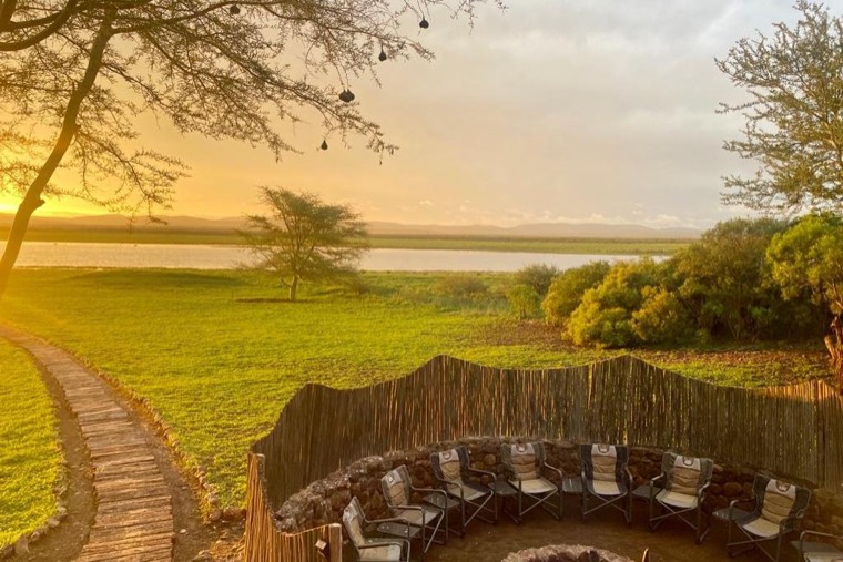 The boma at golden hour with a boardwalk leading to the lake
