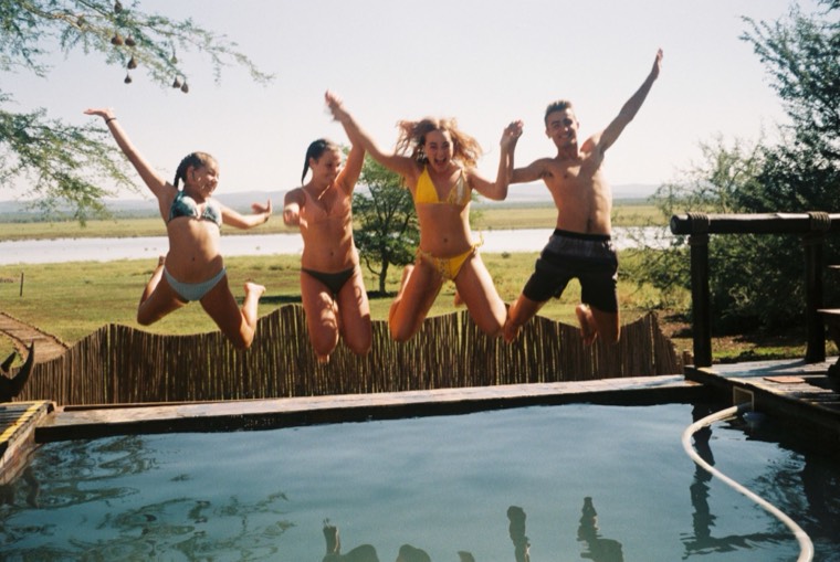 Friends jumping into the lodge pool